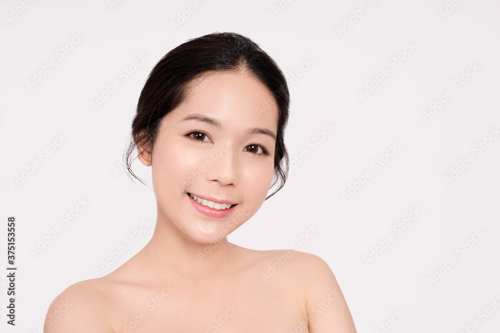 The face of a smiling Asian woman with a clean and beautiful face. The face of a smiling Asian woman with a clean and beautiful face.