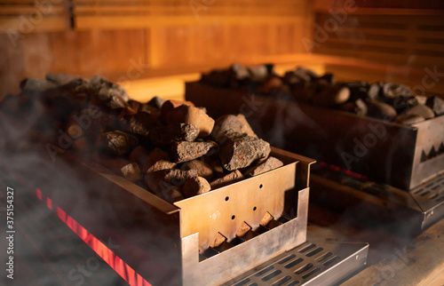 Big heater in Finnish sauna with hot stones