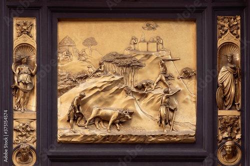 Panel of the Door of Paradise - Cain and Abel. Golden bronze door in  Florence Baptistery. Italy