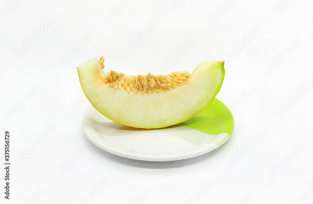 Piece of ripe melon with seeds on a plate Piece of ripe melon with seeds on a plate