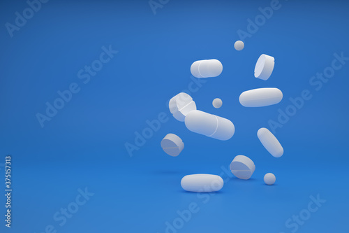 Medical tablets and capsules floating in the air on a blue background. 3D rendering