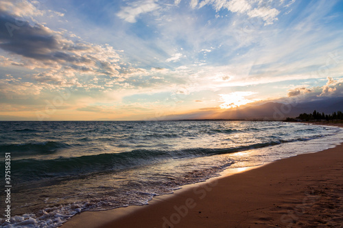 Wallpaper Mural Beautiful sunset by the lake. Bright clouds are reflected in the water. Kyrgyzstan. Torontodigital.ca