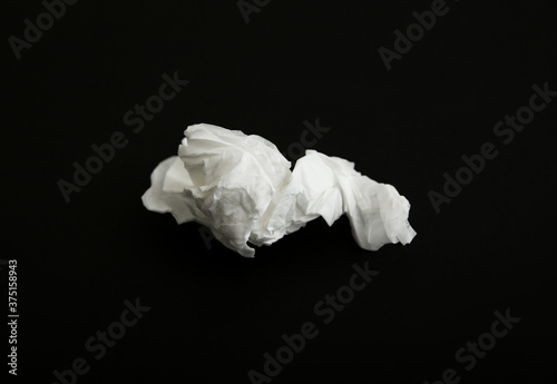 Used white paper tissue on black background
