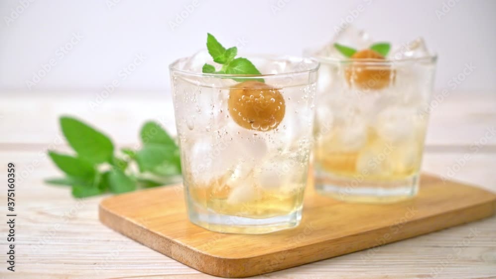 iced plum juice with soda and peppermint on wood table - refreshment drink iced plum juice with soda and peppermint on wood table - refreshment drink