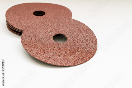 pile of new round sandpaper with white background photo