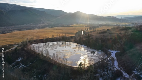 Aerial view of gudron toxic tar waste pits during winter season, afternoon sun. They look like black lakes but are full of petrol toxic waste and owerflowing may cause ecological disaster.