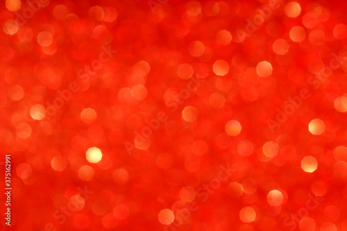Defocused Golden lights.Abstract red bokeh texture background.Christmas shiny background. The concept of the celebration or party