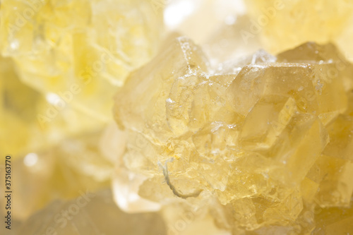 Brown yellow sugar crystals, macro closeup. Sweet background