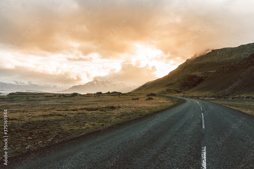 Fototapeta premium Golden hour sunset driving along road