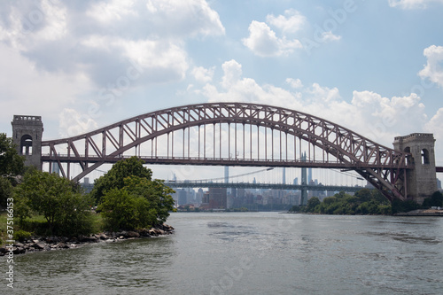The Hell Gate Bridge along the Astoria Queens New York Riverfront over the East River during Summer © James