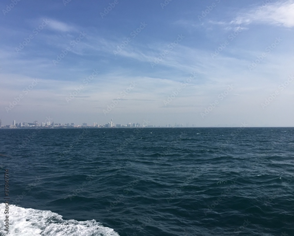 View of Pattaya city in Thailand Asia from a boat, looking at the sea and the skyline in the summer