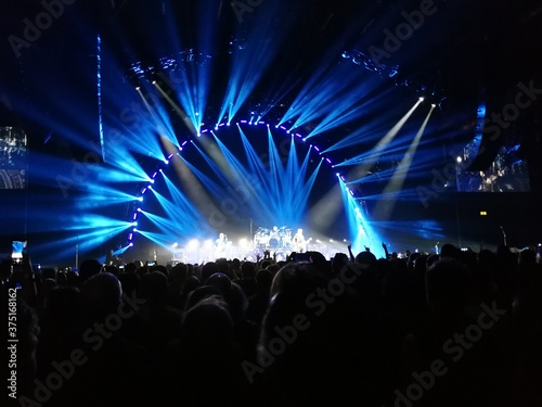 View of the stage at a Killers concert in Birmingham United Kingdom. Light show and packed arena 