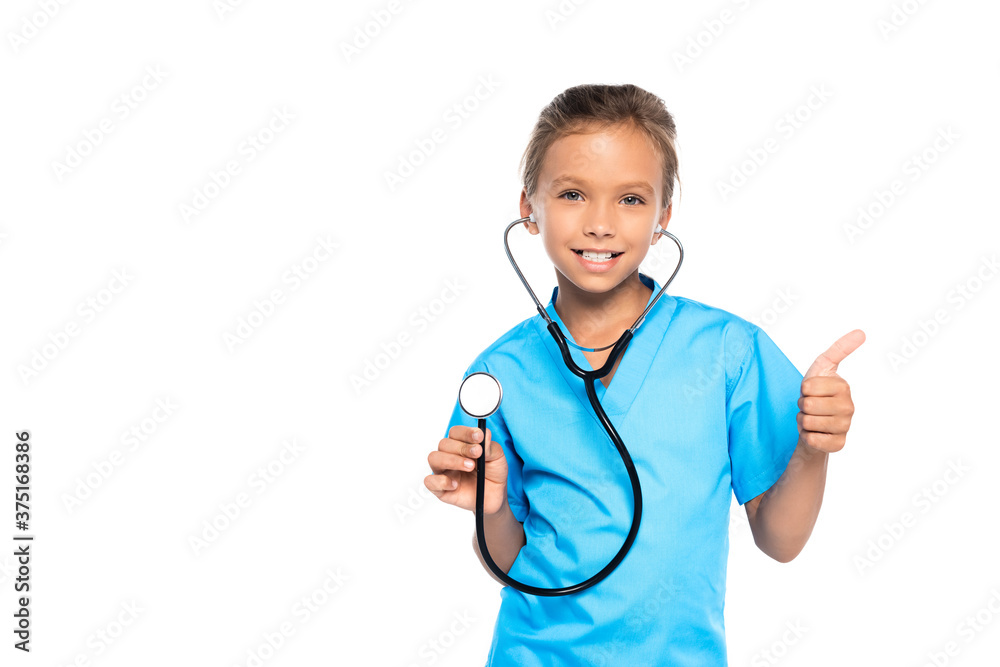 kid in costume of doctor holding stethoscope while showing thumb up isolated on white kid in costume of doctor holding stethoscope while showing thumb up isolated on white