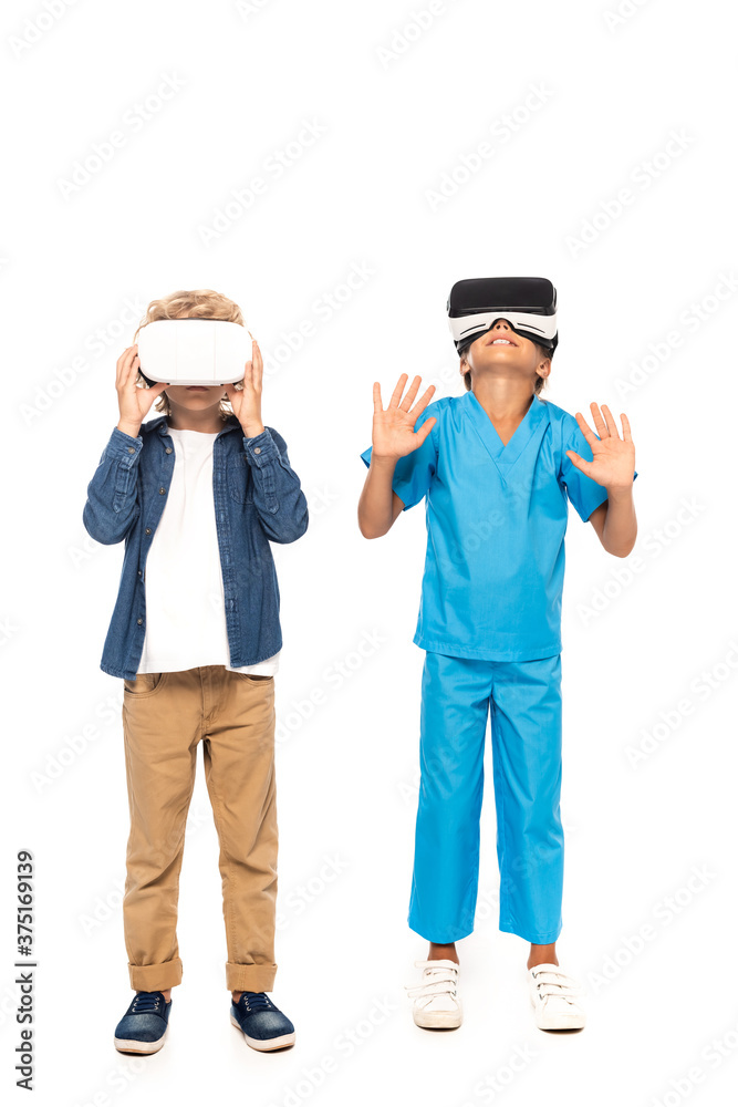 boy touching virtual reality headset while kid gesturing isolated on white boy touching virtual reality headset while kid gesturing isolated on white