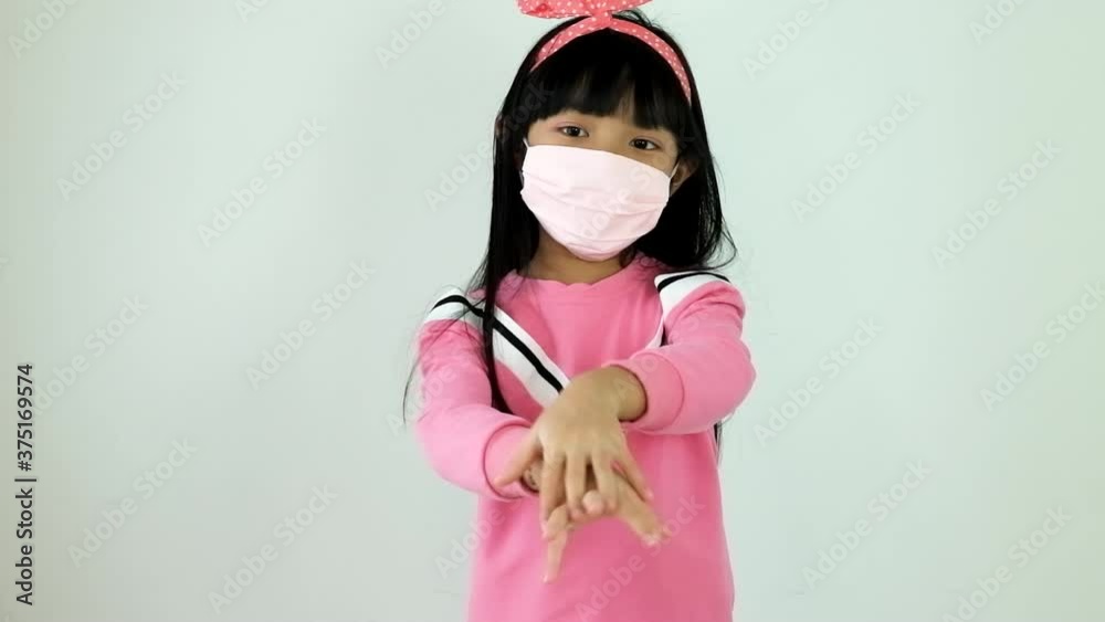 Asian child girl is washing her hands with alcohol gel to protect against corona virus or covid 19 on a white background. Asian child girl is washing her hands with alcohol gel to protect against corona virus or covid 19 on a white background.