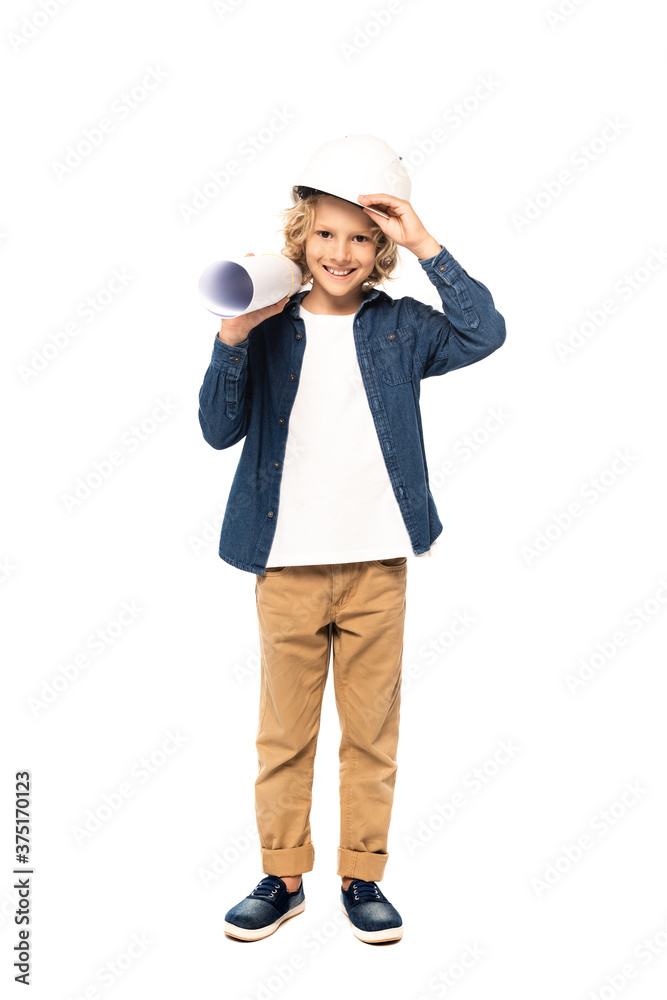 blonde boy in costume of architect touching safety helmet and holding blueprint isolated on white blonde boy in costume of architect touching safety helmet and holding blueprint isolated on white