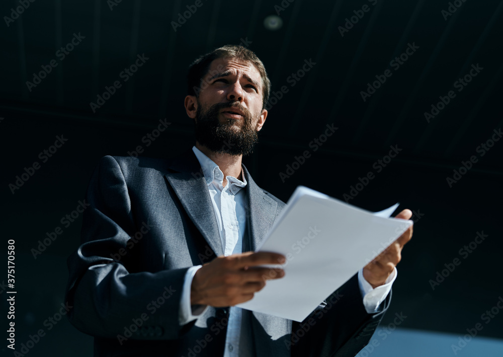 Business man outdoors with documents in hands near building official lifestyle Business man outdoors with documents in hands near building official lifestyle