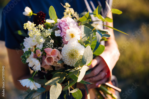 Close up on a beautiful bouquet. Woman holding a bouquet. Wedding and engagement concept. 