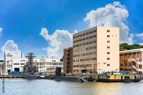 yokosuka, japan - july 19 2020: Submarine Sōryū 16SS and Auxiliary Multi-purpose Support ship JS Enshū AMS-4305 of the Japan Maritime Self-Defense Force berthed in the Yokosuka naval port. photo