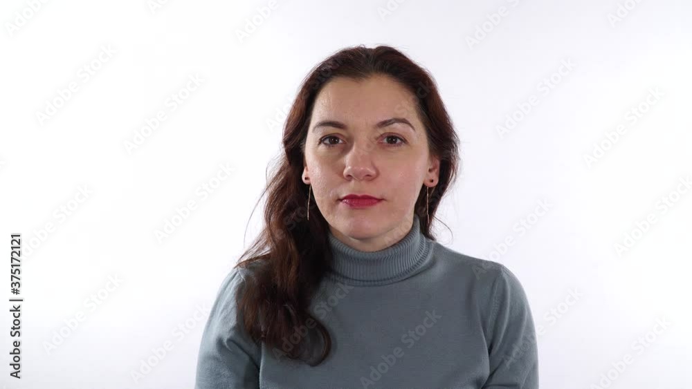 Brunette caucasian woman, 30-35 years show silence gesture. Woman bring her index finger in front of mouth. White background. Brunette caucasian woman, 30-35 years show silence gesture. Woman bring her index finger in front of mouth. White background.
