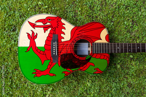 Welsh  flag motif painted on wooden steel string acoustic guitar photo