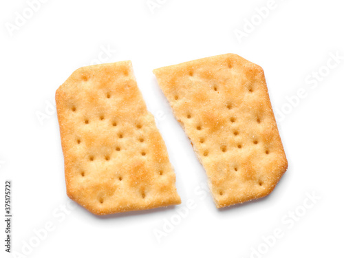 Broken delicious crispy cracker isolated on white, top view