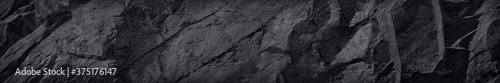 Long banner with stone texture. Black rock background. Website header.