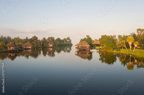 Photography Laguna del Tesoro, Treasure Lagoon, Palm trees and wooden cabins, Zapata Peninsu