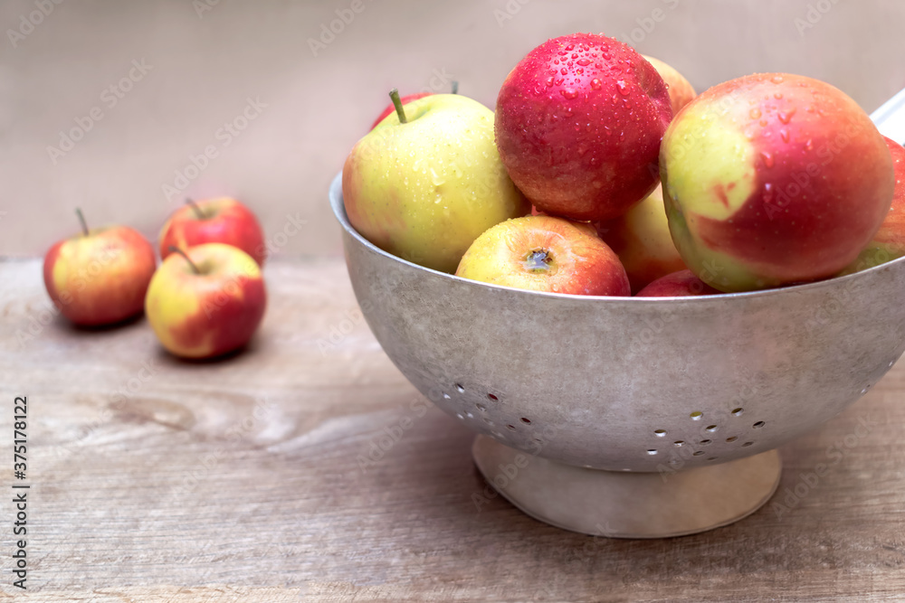 Ripe red apples in metallic bowl on wooden table background with copy space for text. close up of fresh sliced fruits, vitamin fruits banner concept Ripe red apples in metallic bowl on wooden table background with copy space for text. close up of fresh sliced fruits, vitamin fruits banner concept