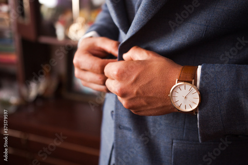 businessman in suit with a clock on his hand