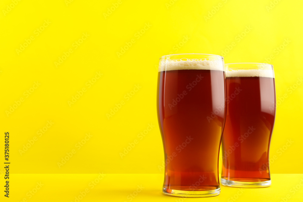 Delicious homemade kvass in glasses on yellow background. Space for text Delicious homemade kvass in glasses on yellow background. Space for text