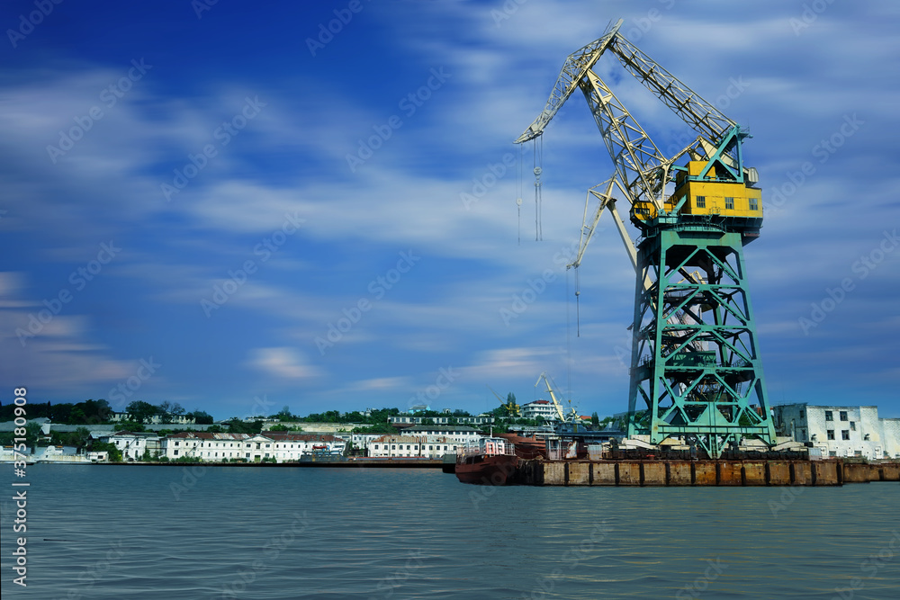 Seascape with a large crane against the sky