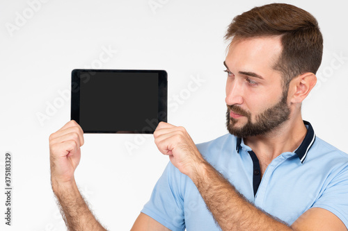 A bearded man with a tablet...
