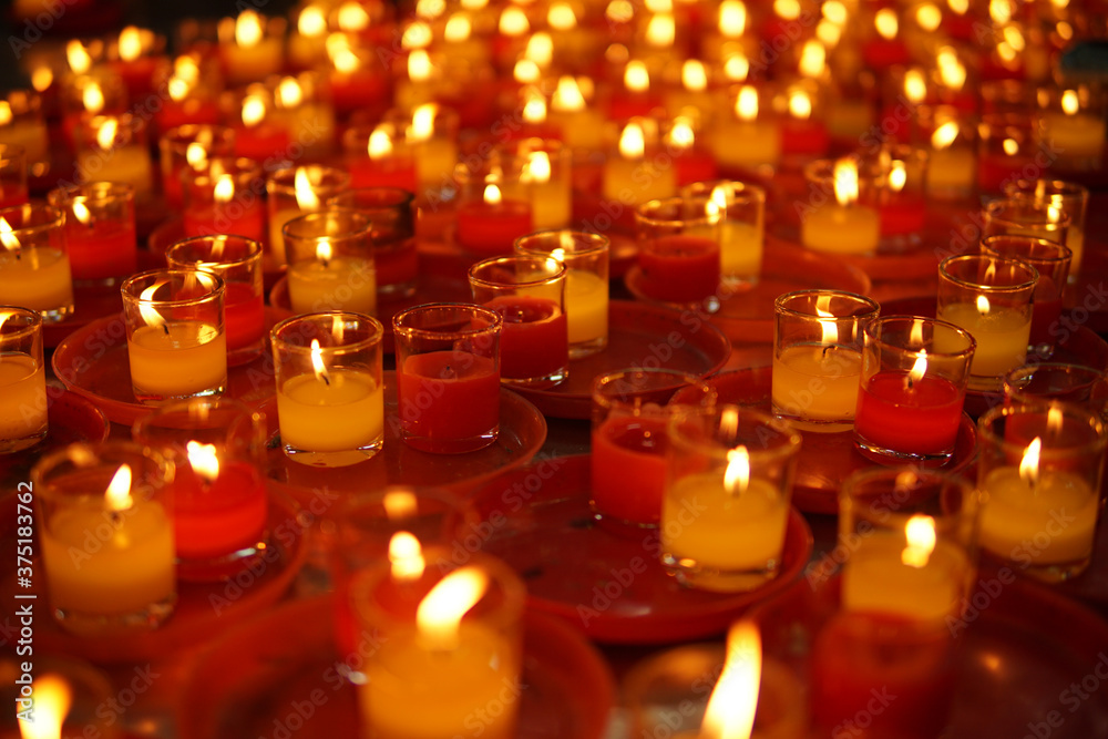 Group of red and white candle in thai temple.