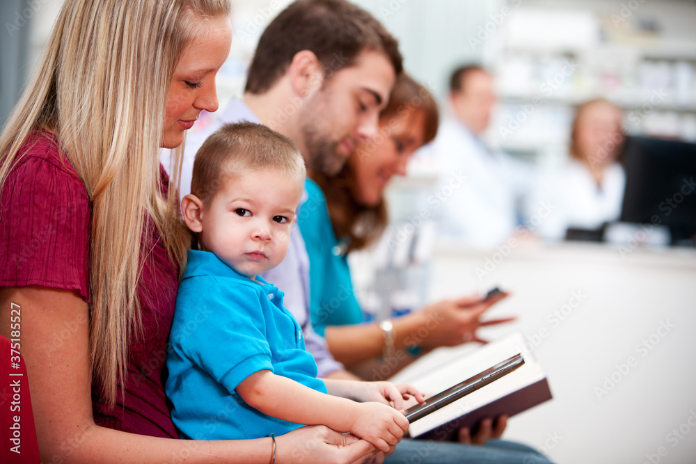 Pharmacy:Child Sitting in Mother's Lap at the Pharmacy Pharmacy:Child Sitting in Mother's Lap at the Pharmacy