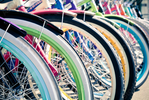 Rows of colorful cruiser bikes for sale photo