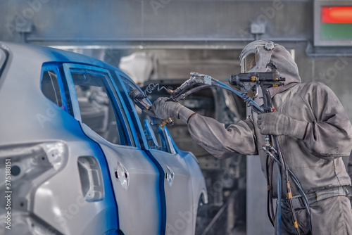 employee body painting workshop carries out painting of the internal elements of the car. © vadimalekcandr