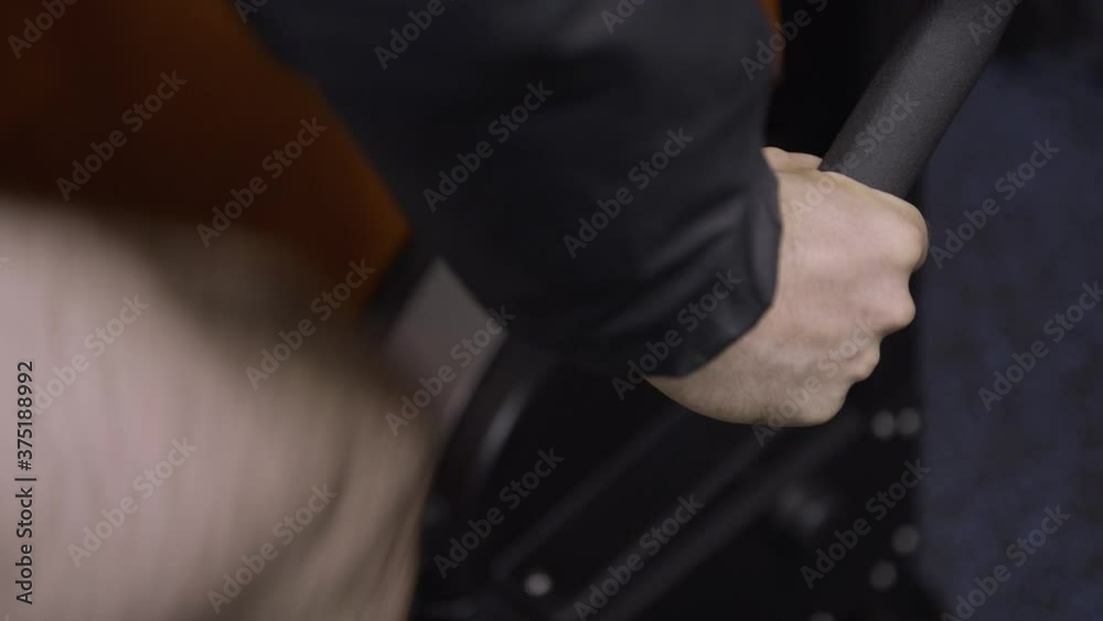 Gym exercise bike pedaling male hand angled closeup Gym exercise bike pedaling male hand angled closeup