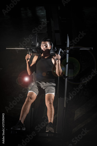 Handsome man doing exercise for buit muscle fit and firm body Lens flare effect model posing