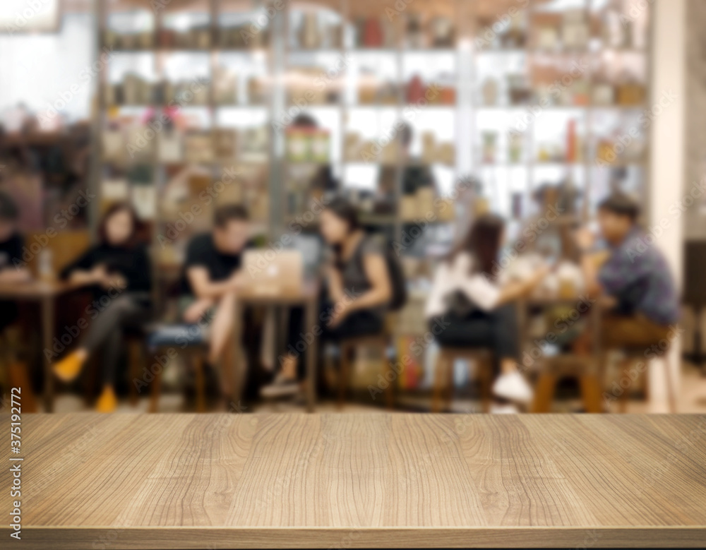 Wooden board empty table top counter of blurred cafe with people on background. Perspective brown wood table over blur background for mock up products display