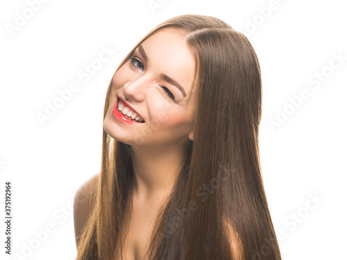 Young beautiful model with make up blinking and smiling at camera isolated on white.