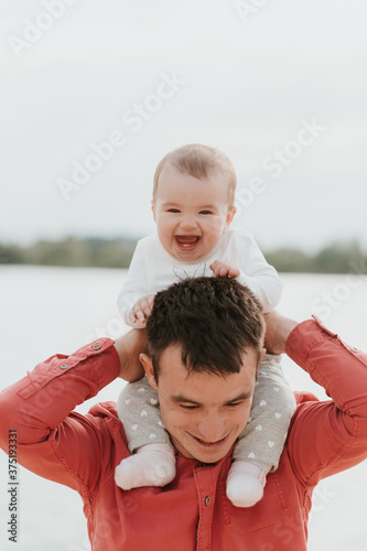 happy father having fun with daughter. family, parenthood, fatherhood and people concept