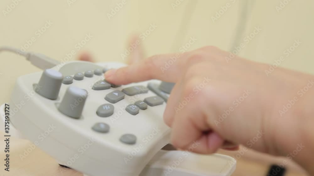 Woman doctor clicks on a device to measure nerve impulses. Woman doctor clicks on a device to measure nerve impulses.