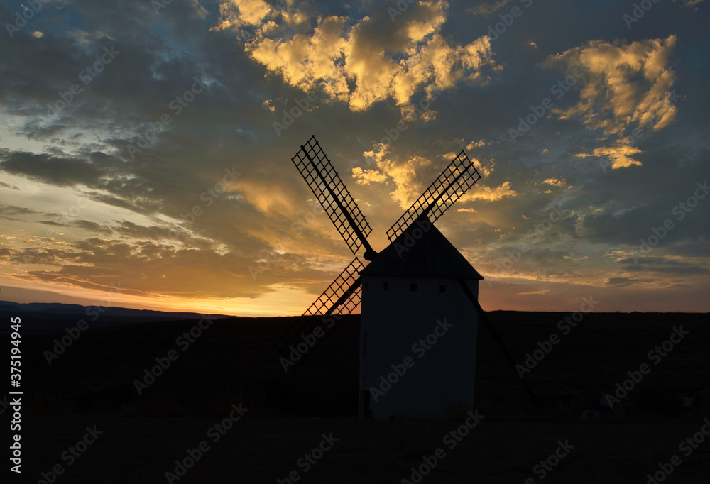 sunset of old spanish windmills on a sunny day with clouds, backlight photography