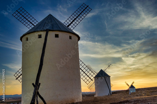 sunset of old spanish windmills on a sunny day with clouds