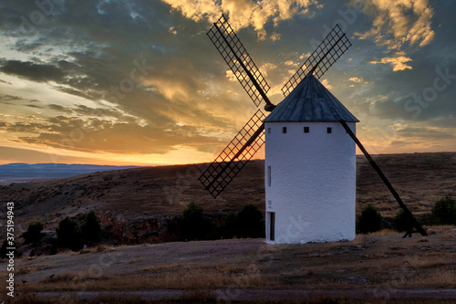 sunset of old spanish windmills on a sunny day with clouds