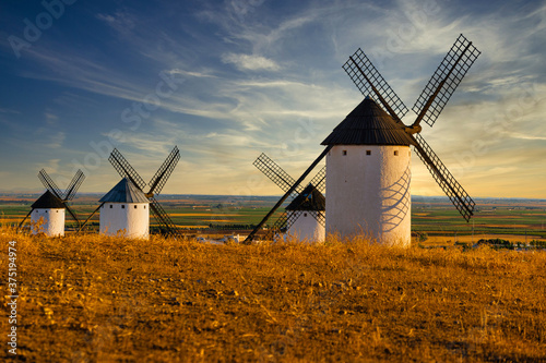 Old spanish windmills on a sunny day with clouds