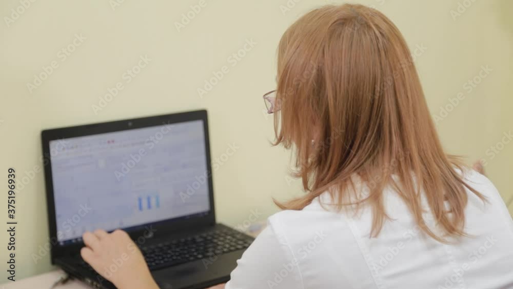 Woman therapist working at the computer. Woman therapist working at the computer.