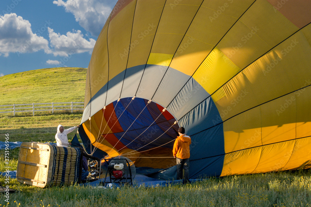 Fototapeta premium Hot air balloon still on the ground and getting filled up with hot air to be ready to fly. 
