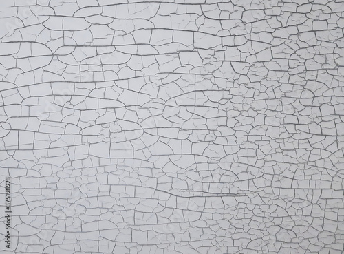 Cracked paint on white black wall